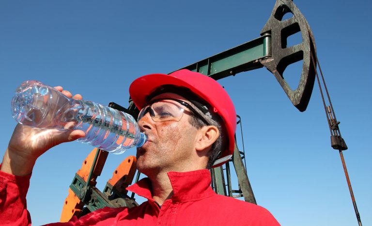 Oil,Worker,Drinking,Clean,Water,From,Plastic,Bottle,At,Oil