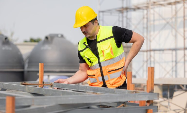 Construction,Worker,In,Safety,Vest,And,Hard,Hat,Inspecting,Structure